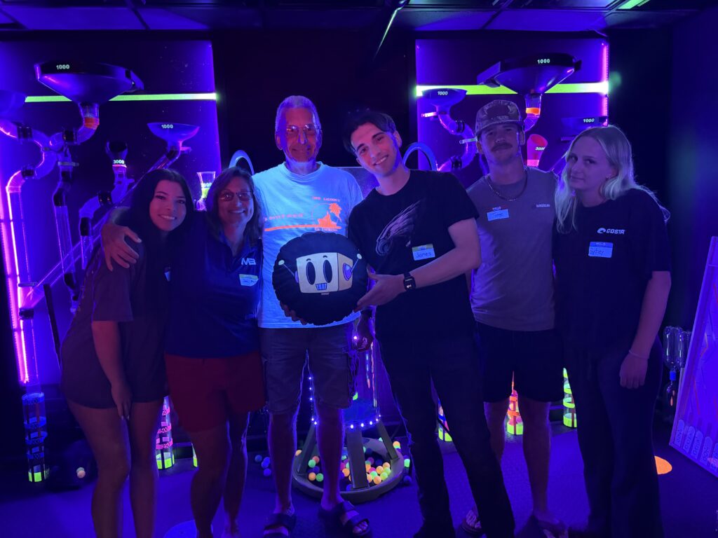Group of players posing with the host after a game show