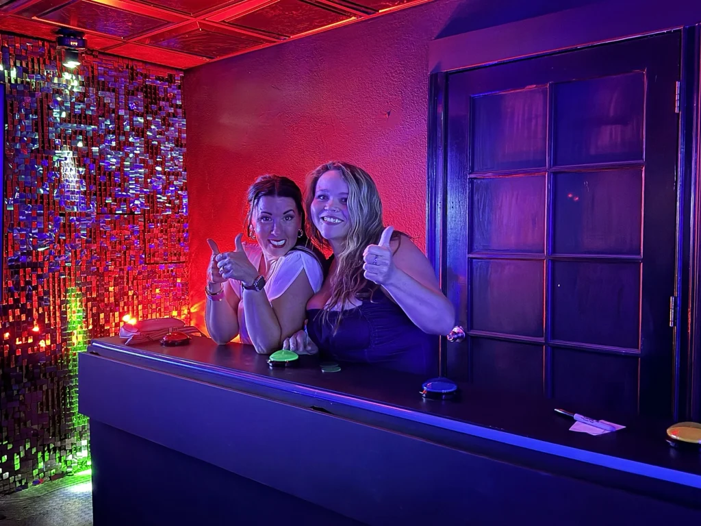 Two players smiling at their podium during a game show