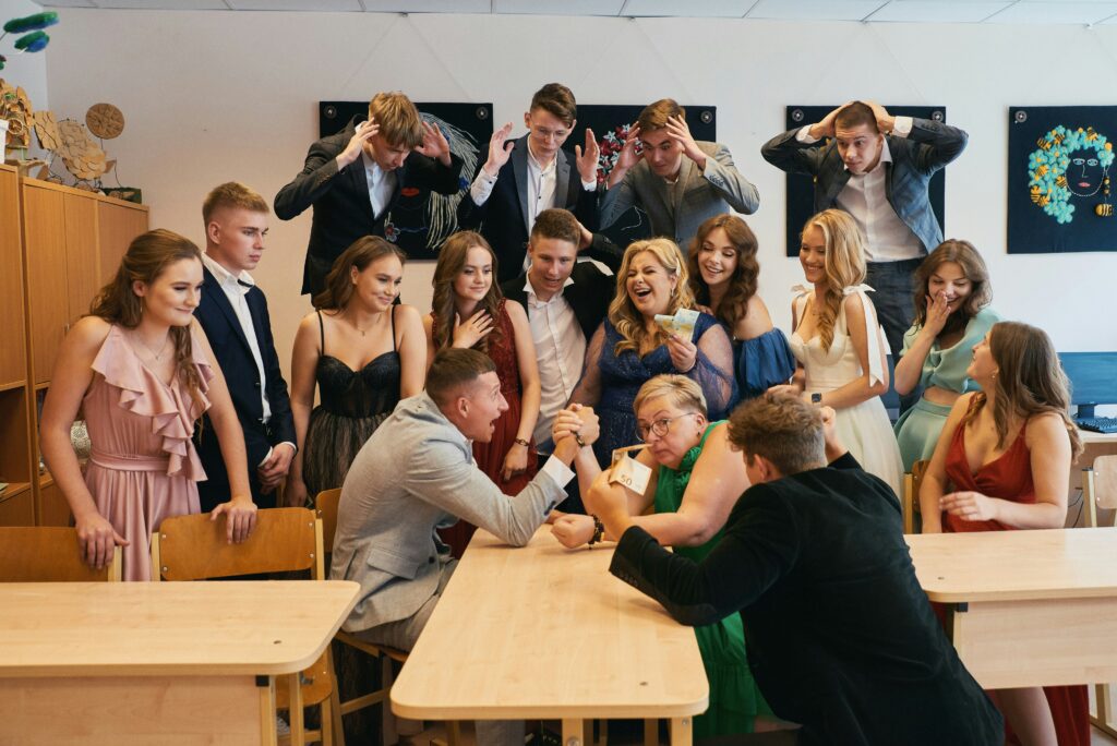 Students and teachers having fun around a classroom table