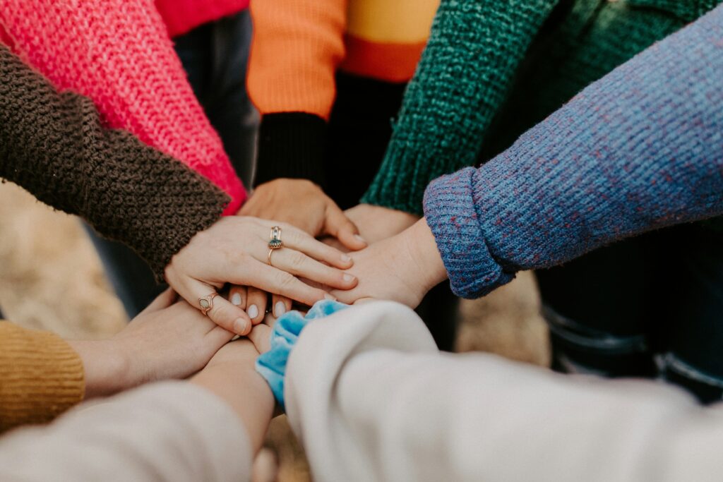 Coworkers stacking hands in a team huddle