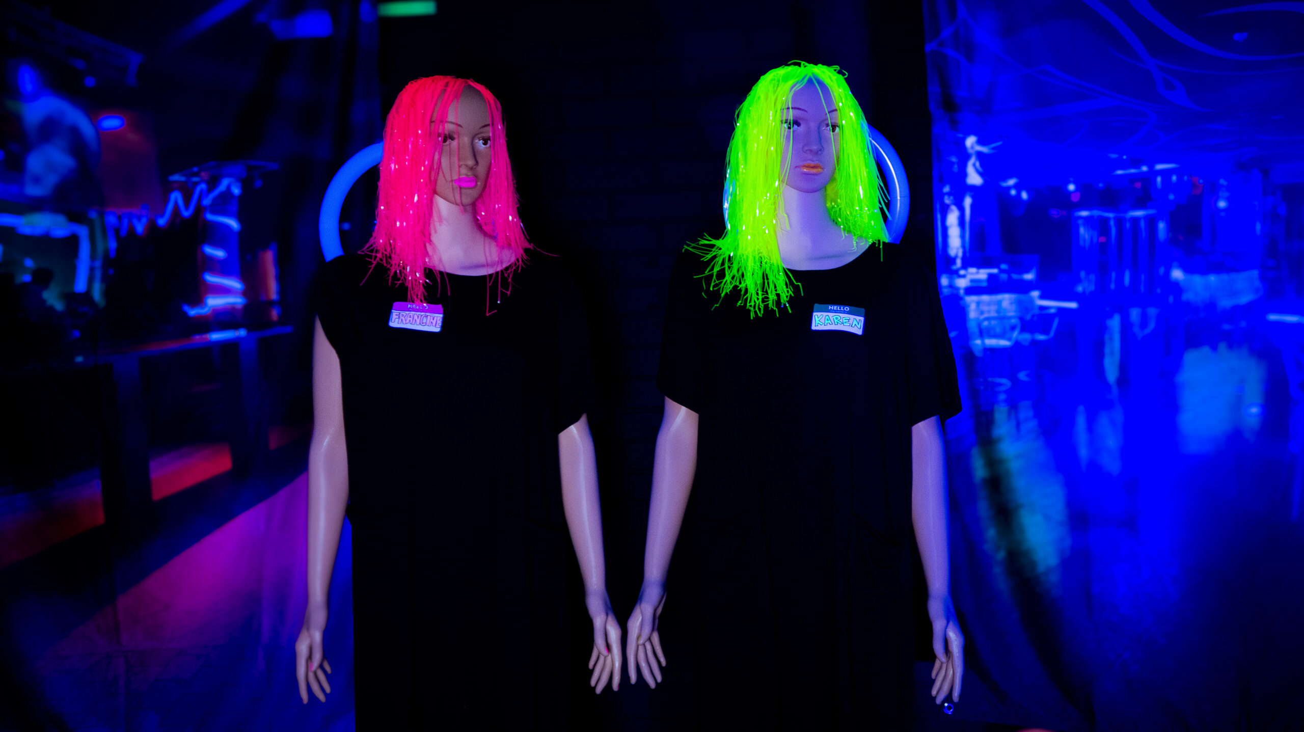 Two mannequins in neon wigs